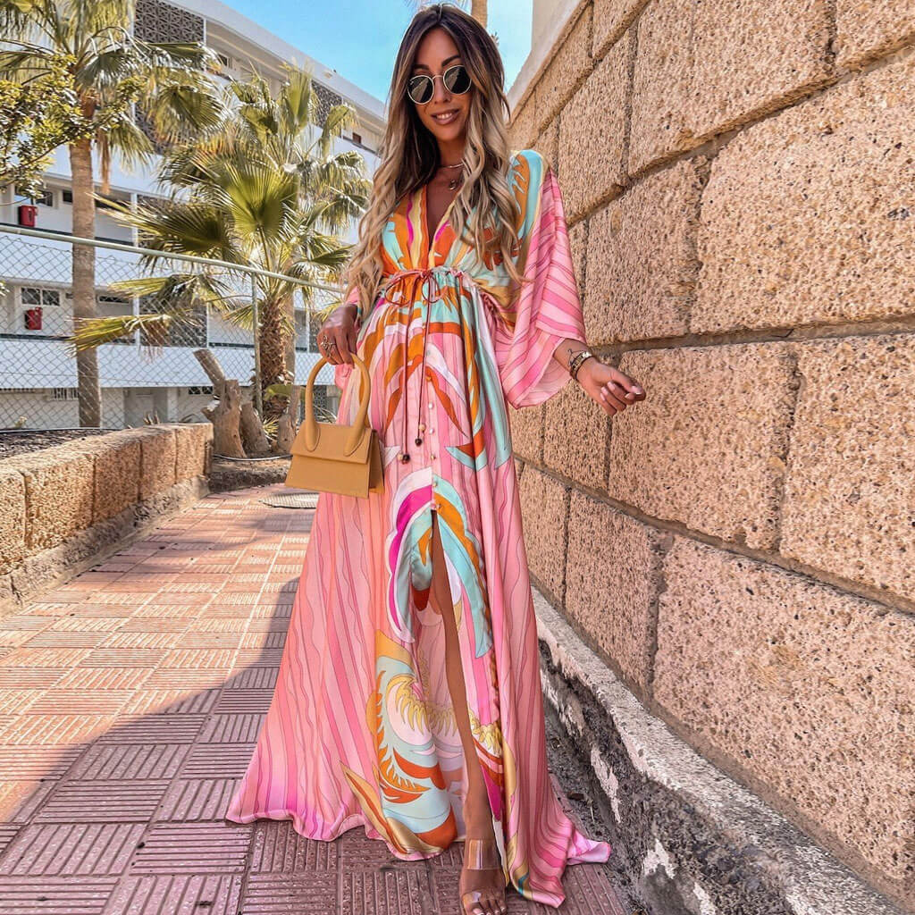 https://cdn.shopify.com/s/files/1/0768/1006/0099/files/CALORA_Abstract-Print-Maxi-Jurk-met-Ceintuur-en-V-Hals-in-Roze-2.jpg?v=1753729047